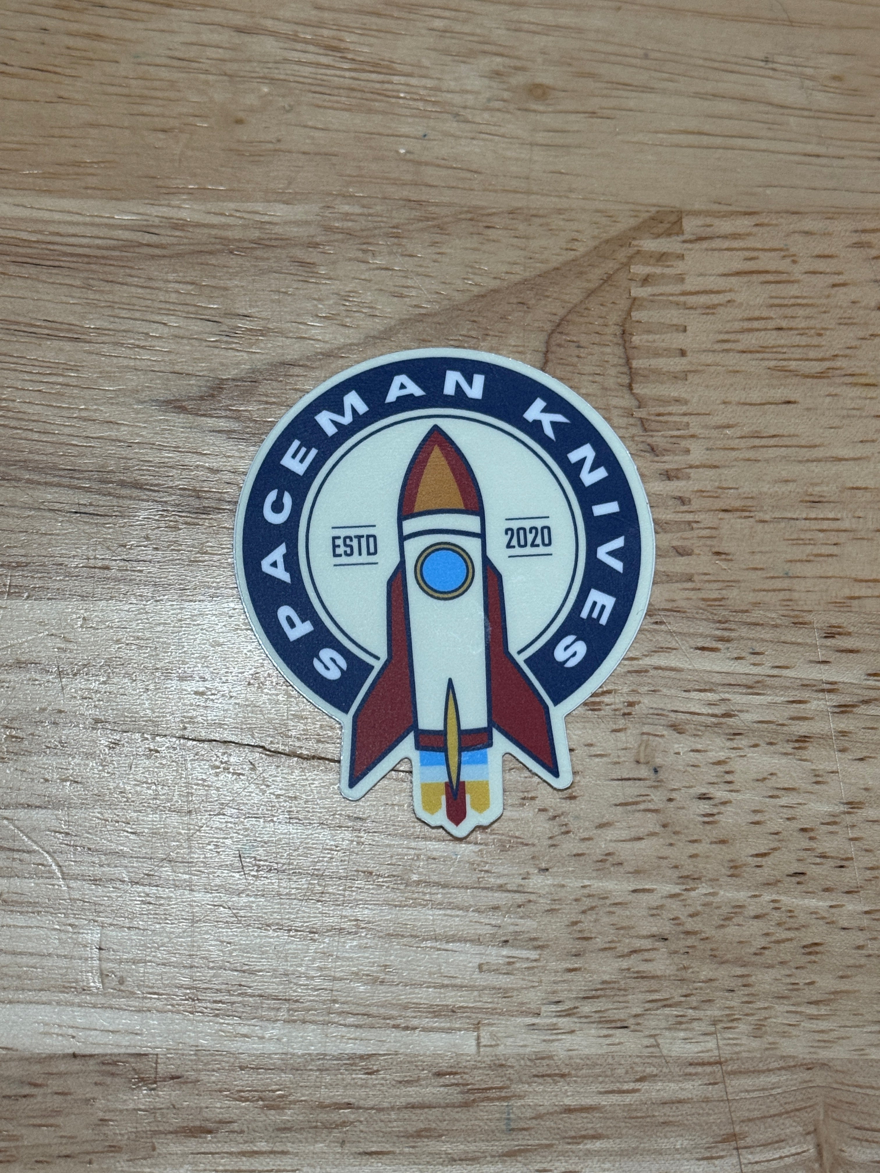 Sticker with a rocket design on a wooden surface